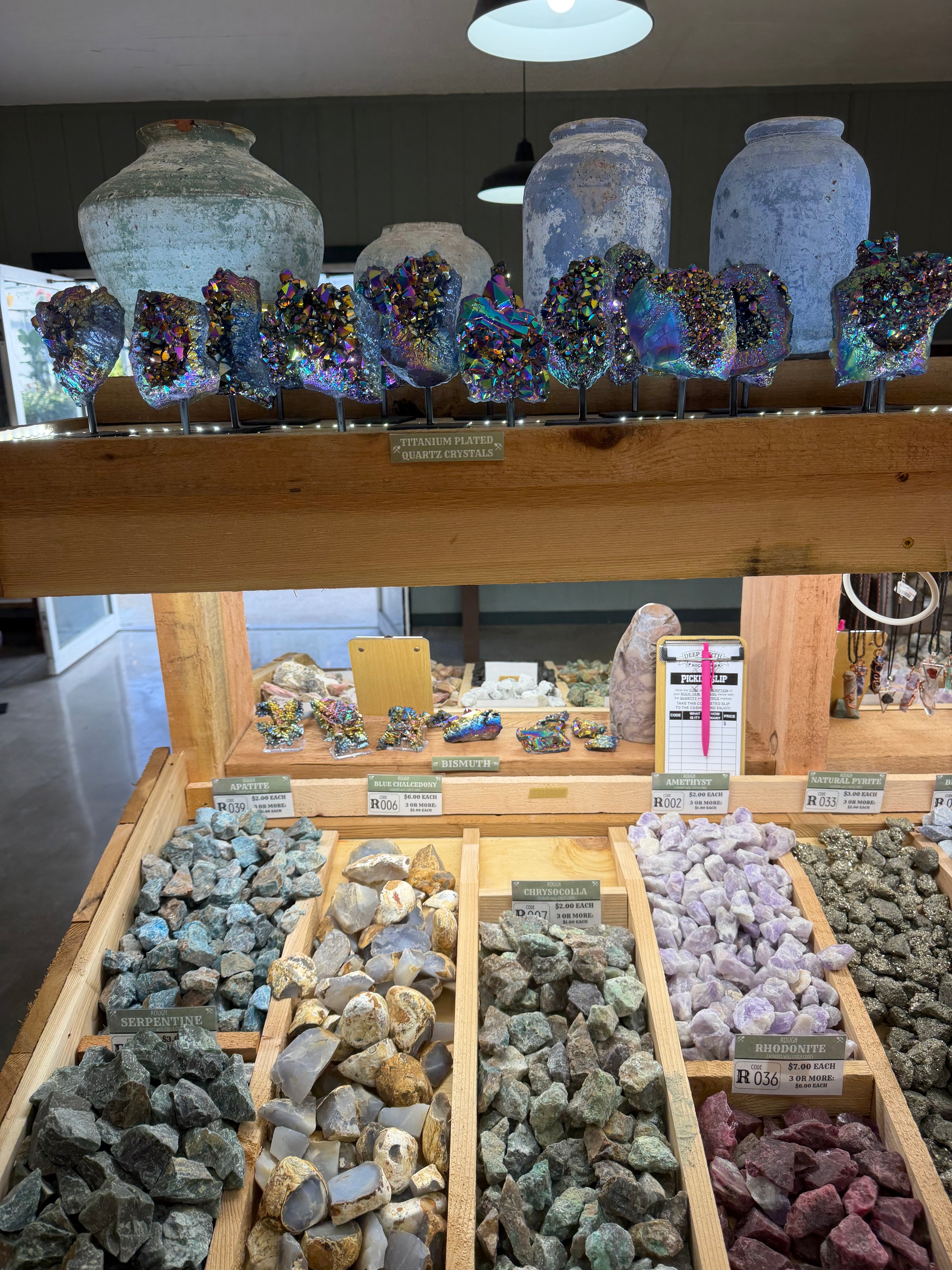 Display of various crystals and rocks in a store setting